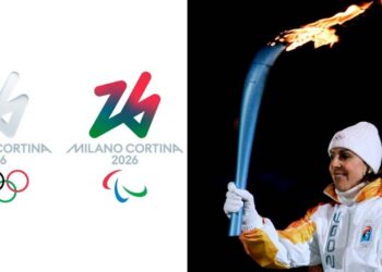Il logo delle Olimpiadi invernali Milano Cortina 2026 e uno dei tedofori con la Fiamma Olimpica